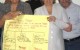 NMAh Ha Paper - 2 ppl holding sign cropped